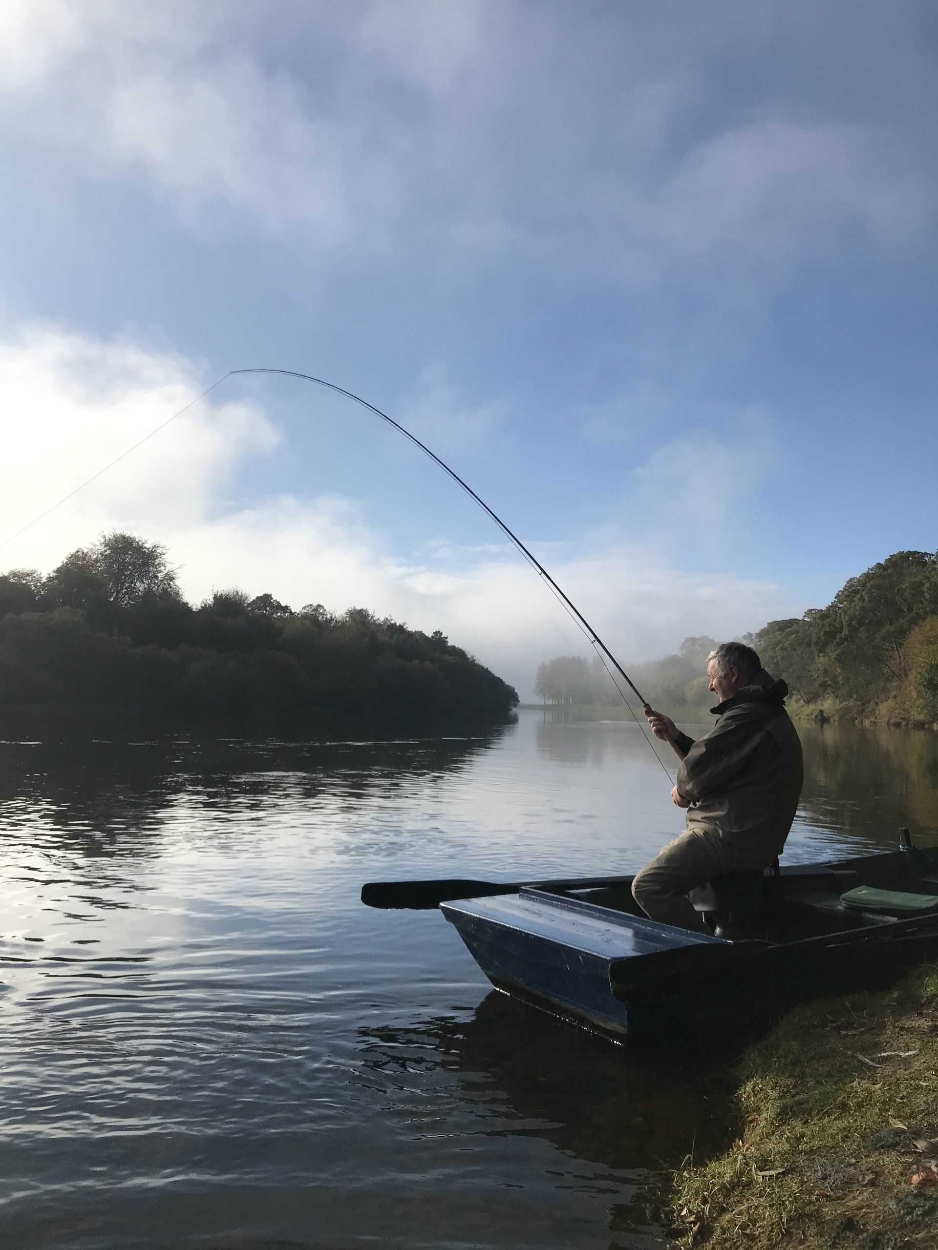A ghillie assisting an angler on the River Tweed