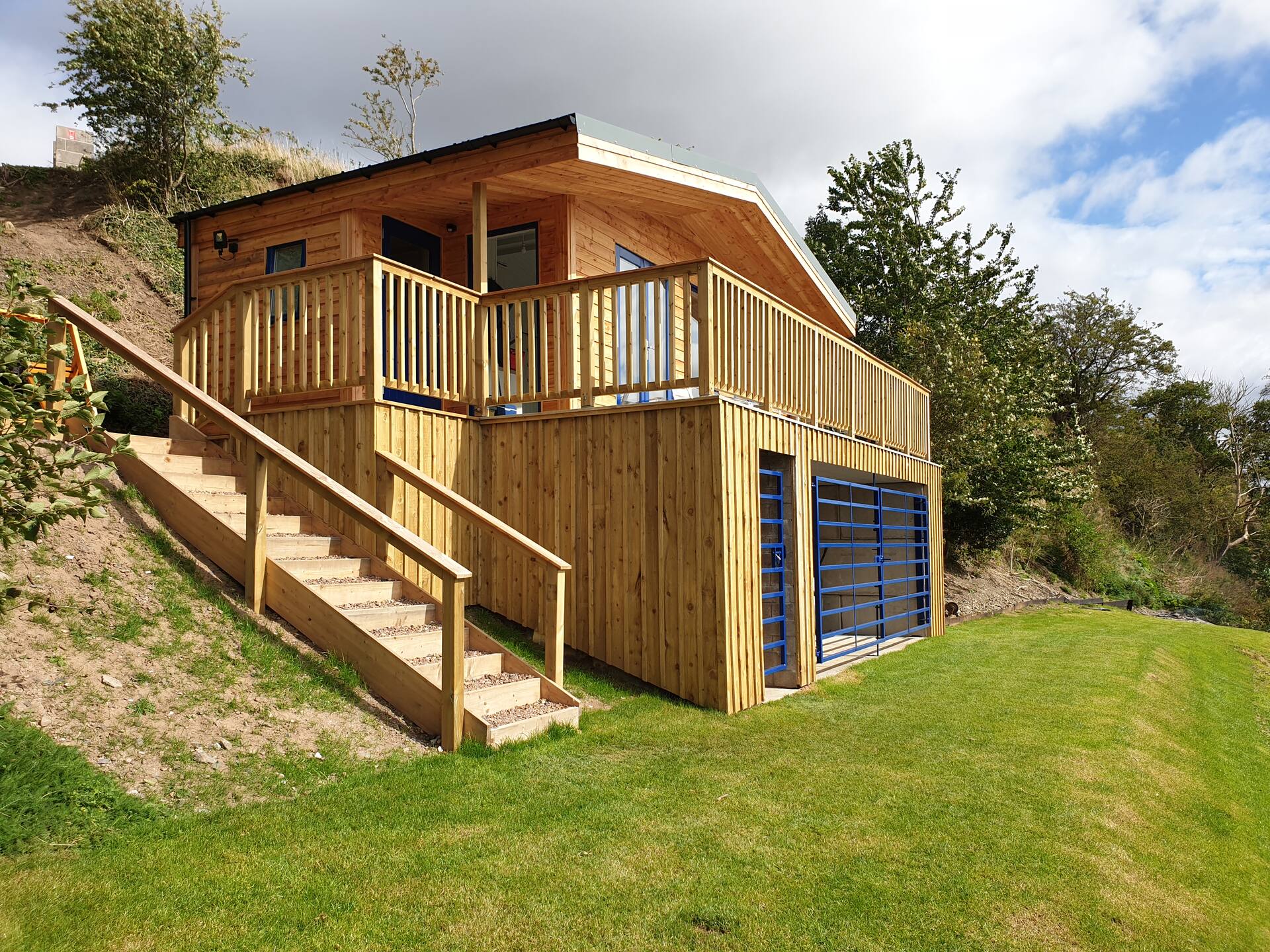 The timber fishing hut at Upper North Wark, with its veranda and boat store, above the River Tweed