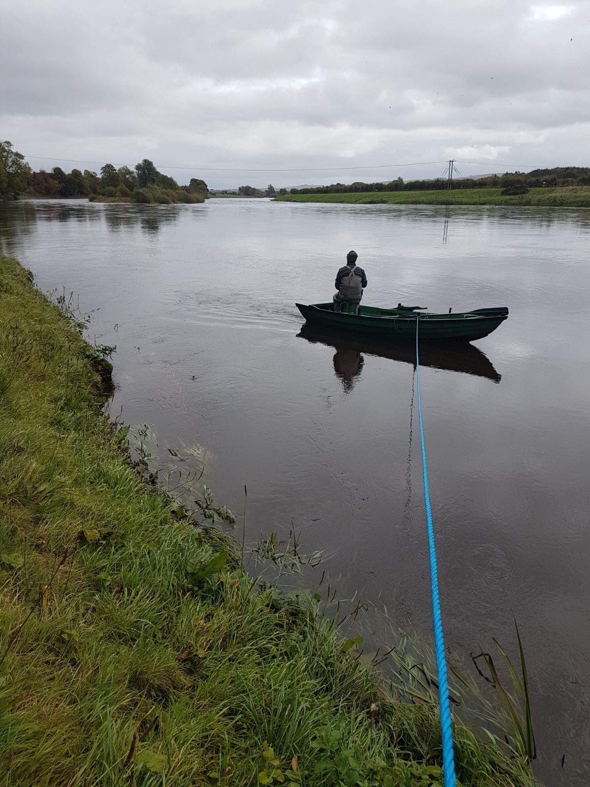 An angler in a boat on the Tweed