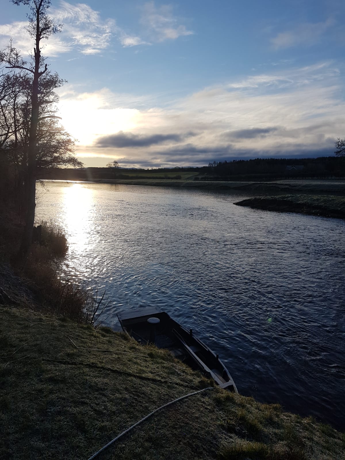 A boat moored at sunset