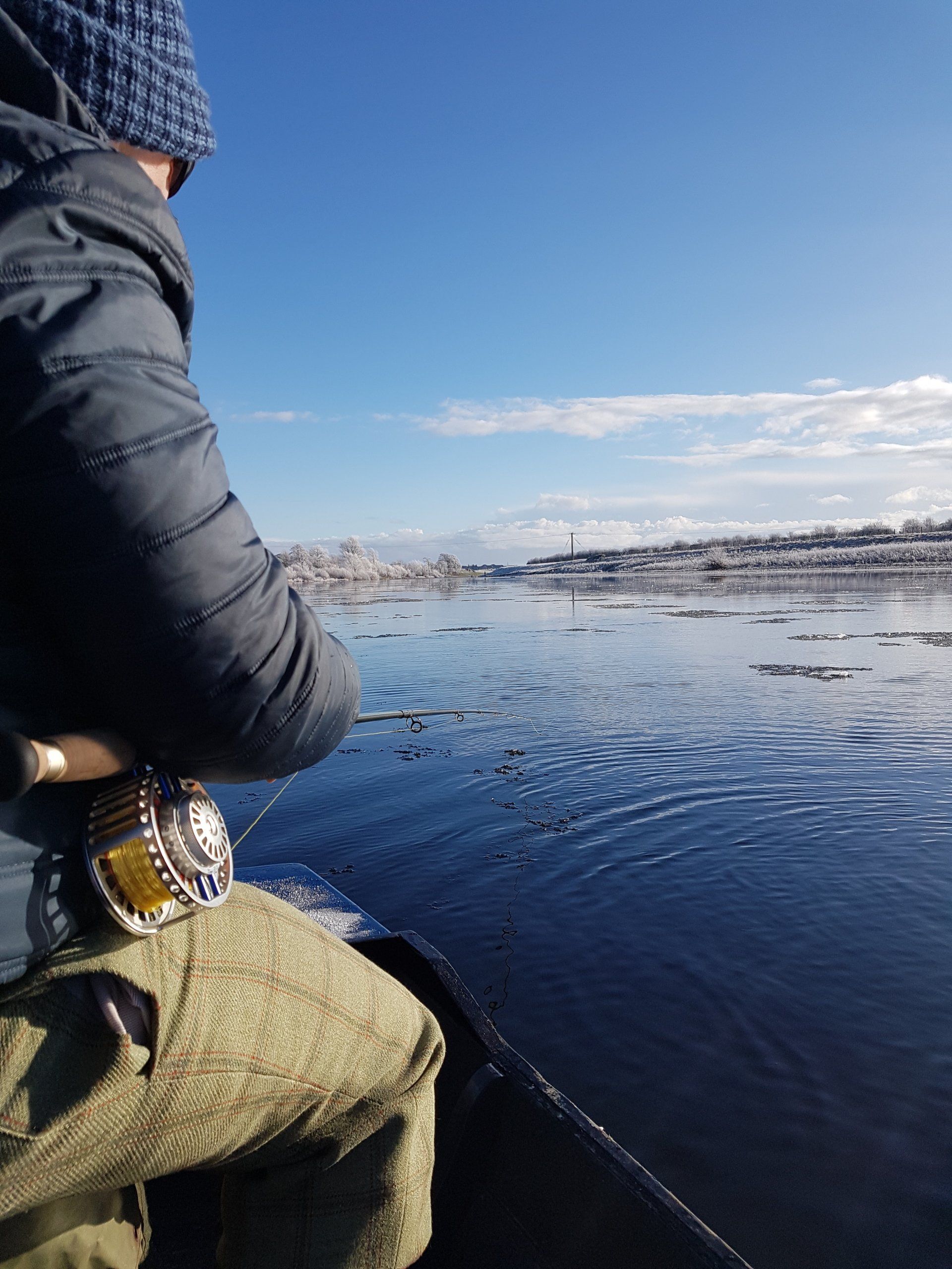 An angler playing a fish from a boat